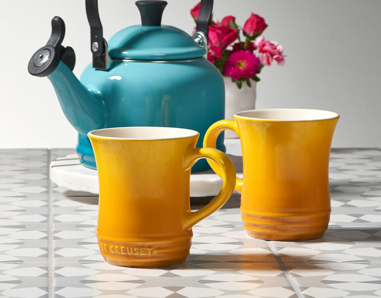 yellow mugs in front of a turquoise tea kettle - links to listings of stores on this page