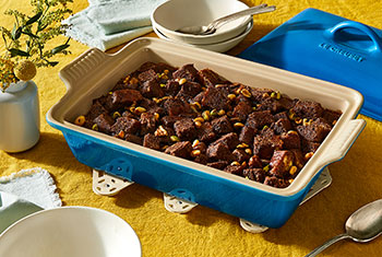 bread pudding in a blue covered baker