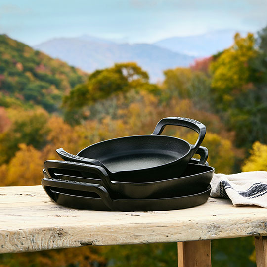ssorted black cast iron pieces from the Alpine collection stacked for storage