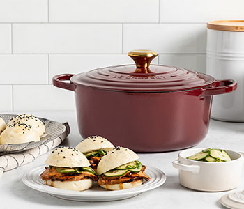 Sesame Steamed Buns in front of a dutch oven