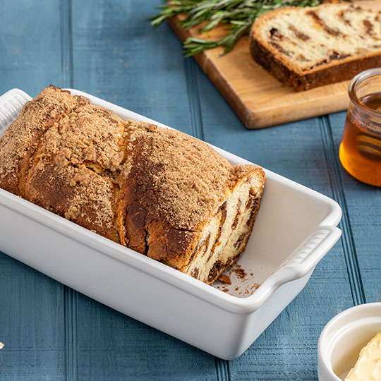 sliced sweet bread next to a sprig of rosemary