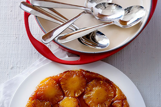 apple tarte tatin alongside spoons for serving