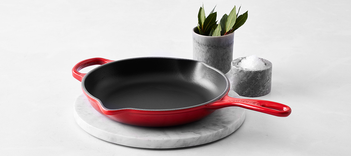 blackened chicken in a white skillet