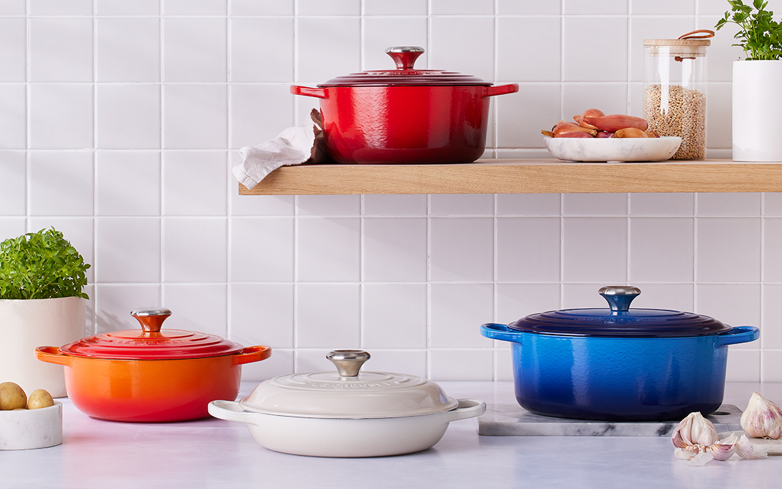 assorted dutch ovens in various shapes, colors and sizes