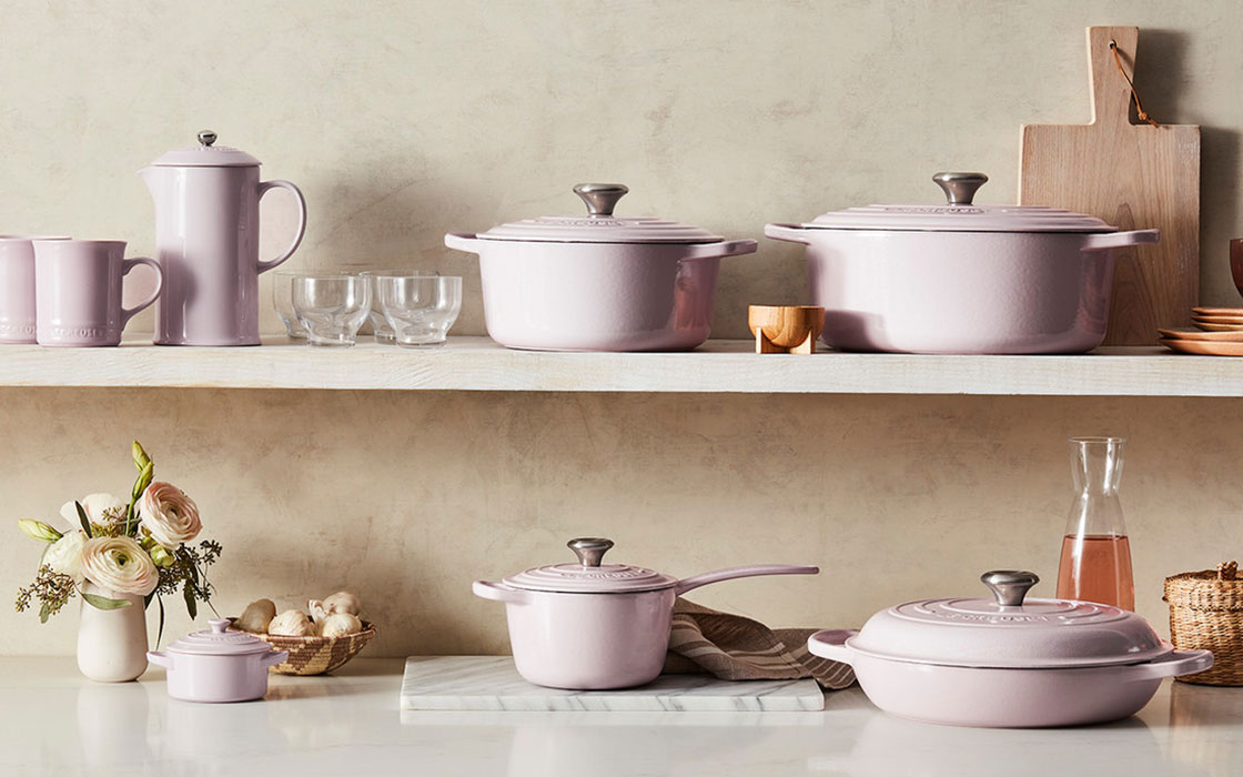 soft pink cookware with other neutrals on shelves