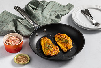 fish cooking in a nonstick pan