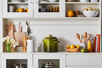assorted cookware on a shelf unit