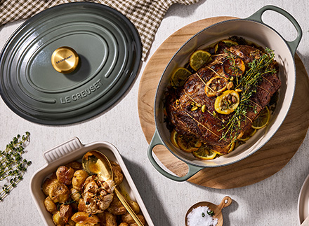 thyme green dutch oven lid surrounded by herbs