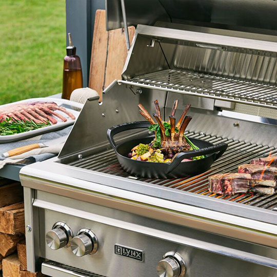 cooking a meal on a grill with assorted black cast iron pieces from the Alpine collection