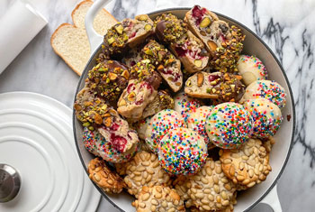assorted holiday cookies piled high in a dutch oven