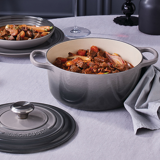 dutch oven filled with soapy water and a sponge