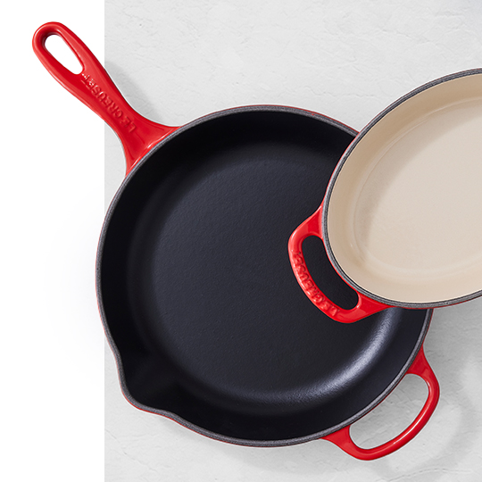 skillet with rough black enamel juxtaposed with a braiser coated in smooth sand-colored enamel