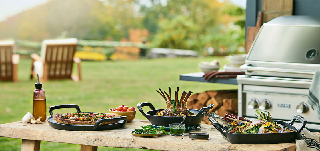 alpine collection cookware next to a gas grill at an outdoor picnic area