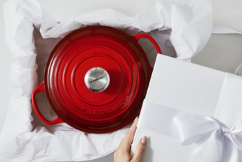 red casserole with white ribbon