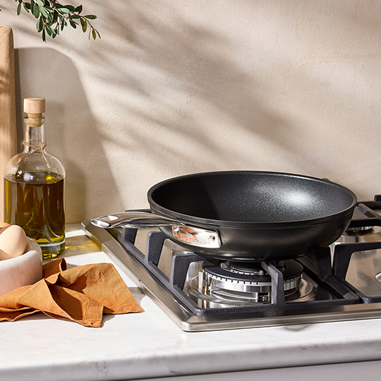 wiping the inside of a pan with a paper towel