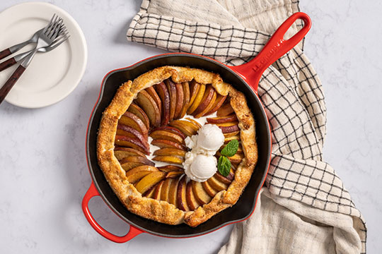 peach tarte tatin topped with ice cream