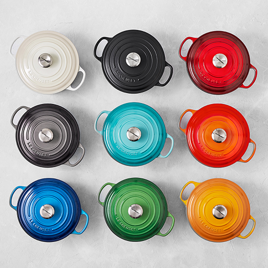 dutch ovens in different colors on a countertop