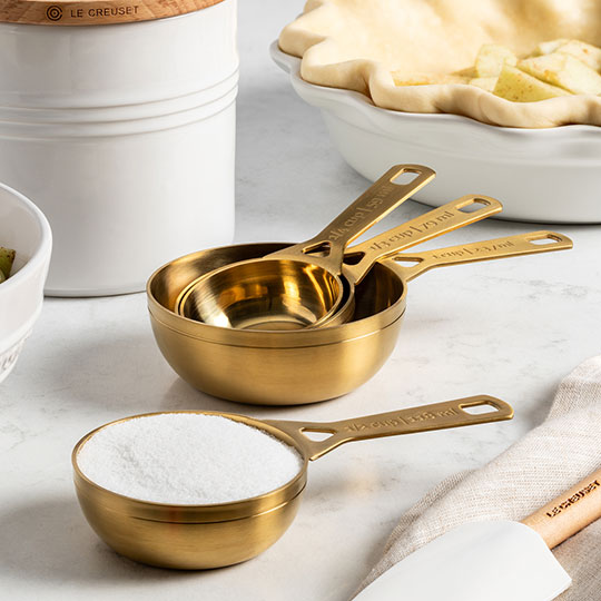 measuring cups in a gold finish