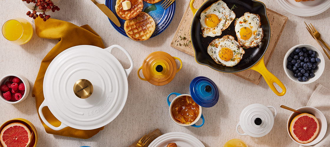 Assorted colorful cookware spread on a table