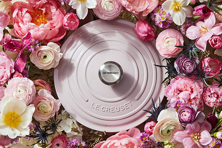 soft pink dutch oven lid surrounded by flowers