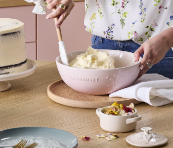 Woman mixing icing in a bowl with a floral relief