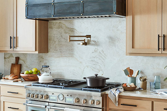 kitchen featuring a marble backsplash and pot filler