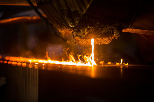 pouring molten cast iron into molds