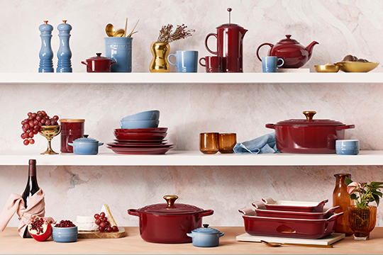 elegant shelves filled with decor and cookware in wine red and light blue