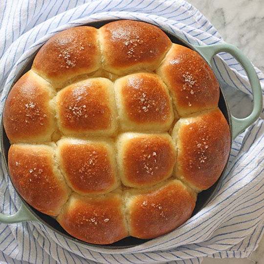 freshly baked dinner rolls in a bread oven