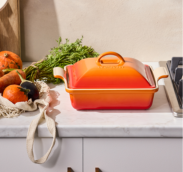 flame dutch ovens next to a pepper mill