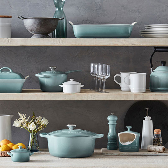 assorted colorful cookware on shelves