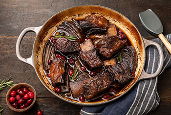 short ribs in a rich brown sauce with caramelized veggies