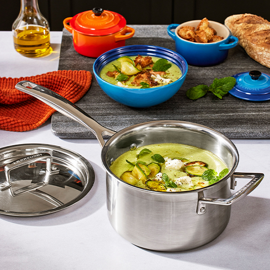 stainless saucepan filled with peach slices and cherries