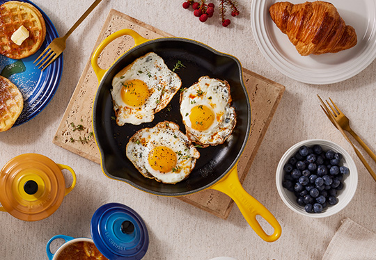 rustic apple pie in a light blue enameled cast iron skillet