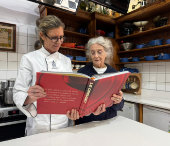 Alicia and her daughter Carianne reading the Le Creuset Assouline Book
