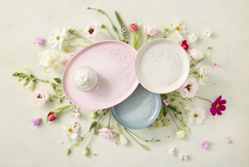 flat lay of plates and bowls with flowers