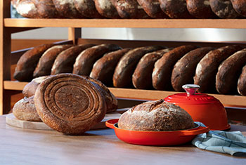 freshly baked bread in a flame orange bread oven