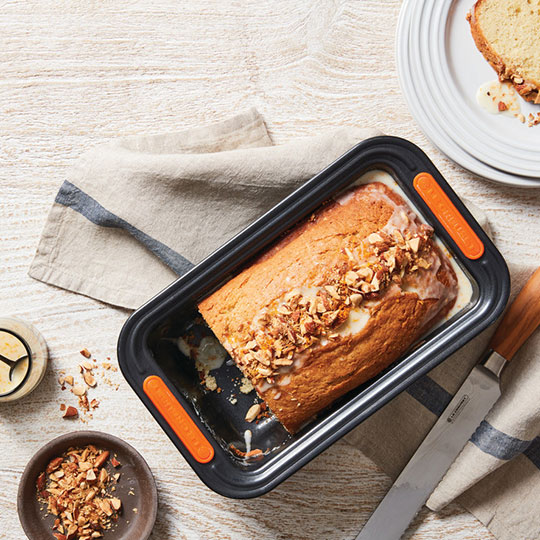 pound cake topped with nuts and a glaze