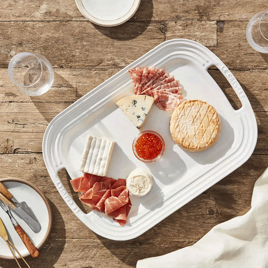 meat and cheese on white serving platter