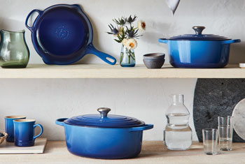 azure blue cast iron cookware on shelves