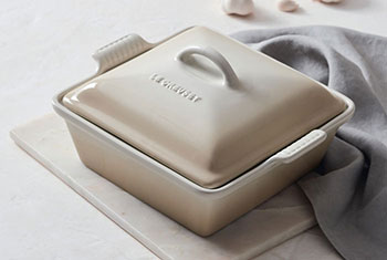 cream colored covered stoneware baker