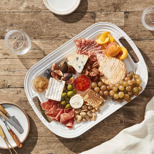 filled out platter with nuts, honey, fruit, cheese and meat