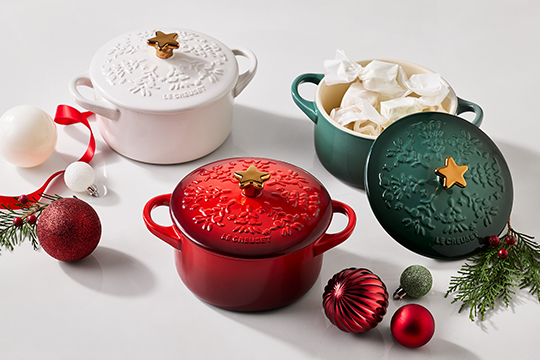 mini cocottes in red, white and green with holiday patterns embossed on the lids and golden star-shaoed knobs