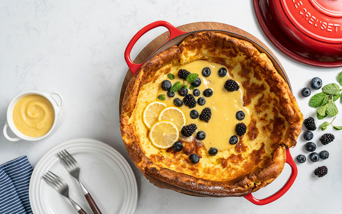 large pancake with creamy sauce and fruit