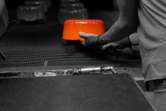 a flame orange dutch oven in the factory