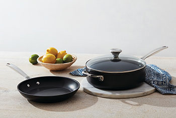 nonstick pans on a counter with lemons
