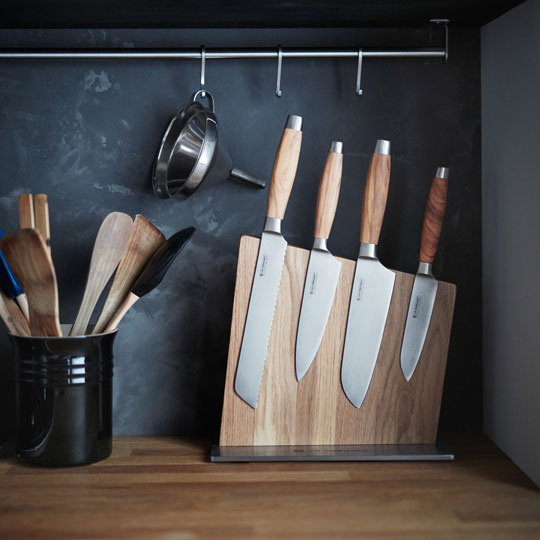 wood handled knives on a wooden magnetic knife block