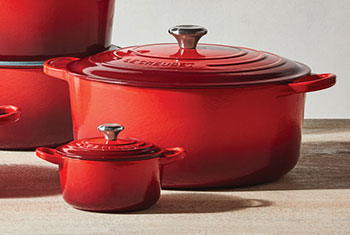 differing sizes of red dutch ovens