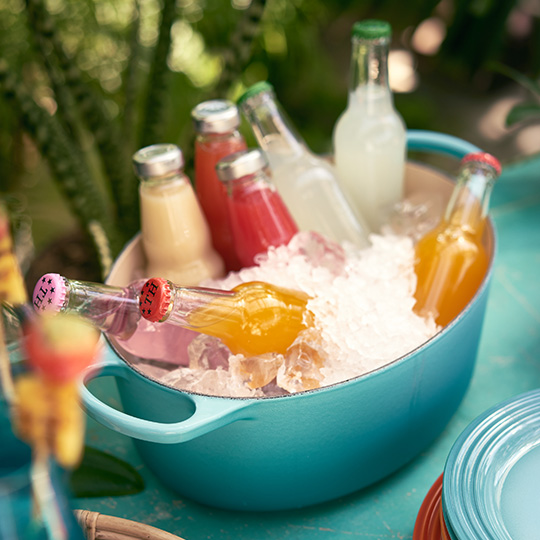 Cast Iron Casserole filled with ice and bottles of beer and soda