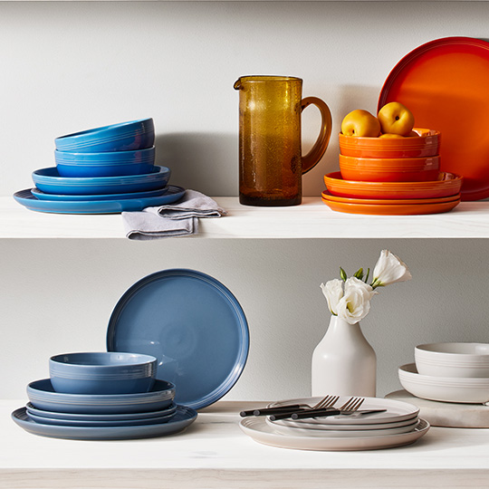 stacks of colorful dinnerware on shelves